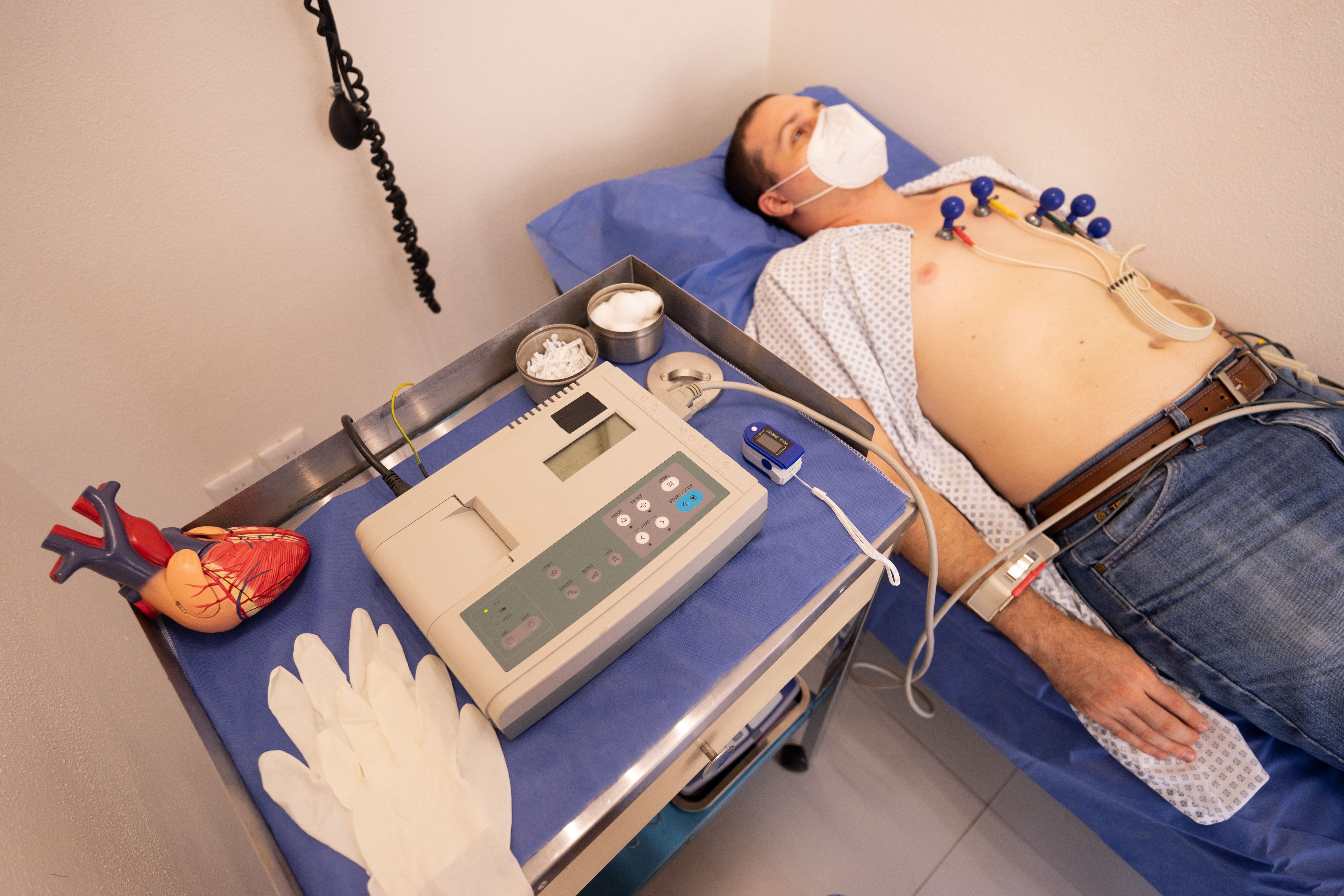 Man undergoing a cardiology ECG exam to monitor heart health