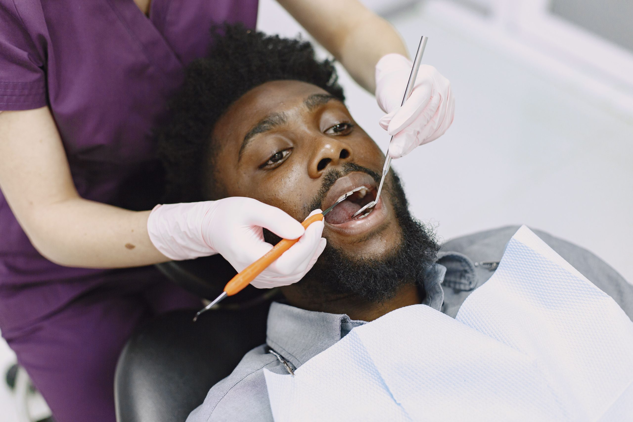 Dentist examining a patient's teeth during a routine dental checkup
