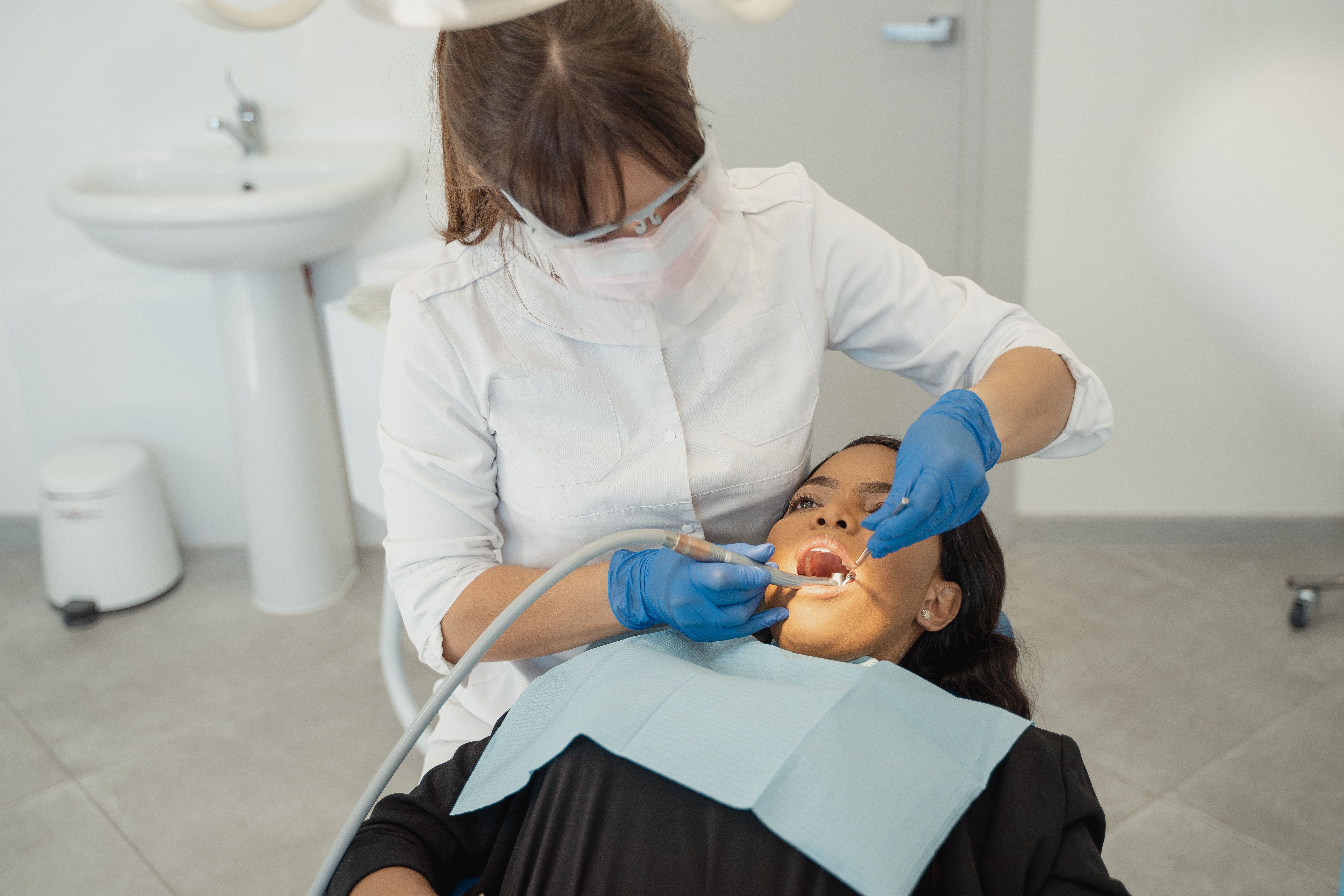 Dentist examining a patient's teeth during a routine dental checkup